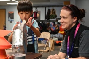 Kid and Teacher doing experiment Kid and Teacher doing experiment