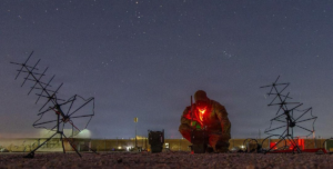 An Army soldier operates tactical communications in the field.
