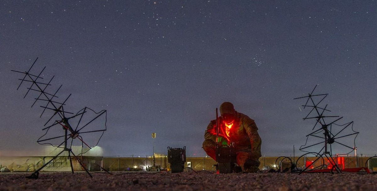 An Army soldier operates tactical communications in the field.